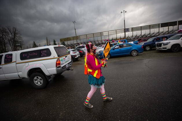 January 17, 2021, Mission, BC, Canada: A person directs traffic as people wait to participate in an anti-bullying parade of more than 1,000 vehicles in support of a transgender teenager who was allegedly assaulted outside a school, in Mission, B.C., on Sunday, January 17, 2021. According to RCMP two students were arrested and charges were recommended in regards to the incident that was recorded and posted online. Mission Canada - ZUMAc35_ 20210117_zaf_c35_057 Copyright: xDarrylxDyckx
