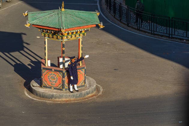 THIMPHU - January 5, 2018: Traffic police regulating traffic in Thimphu, Bhutan. Policeman regulating traffic. Thimphu is the world s only capital without traffic lights. Copyright: xoffenberg@gmx.dex