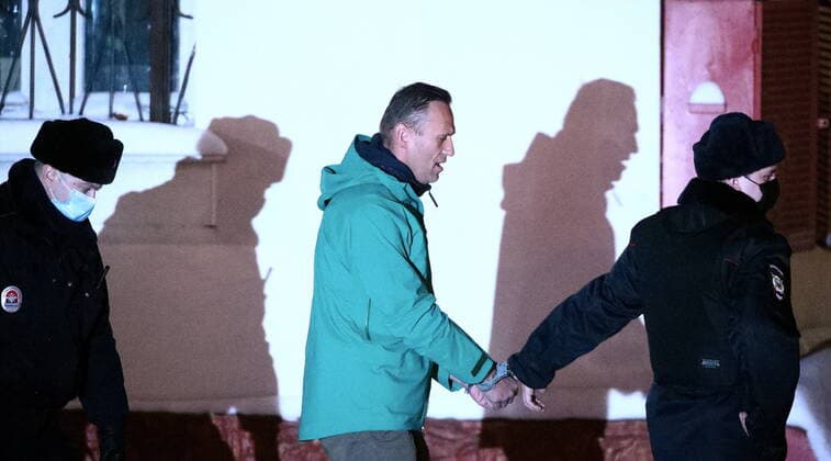KHIMKI, MOSCOW REGION, RUSSIA - JANUARY 18, 2021: Russian opposition activist Alexei Navalny, detained upon arrival to Sheremetyevo International Airport on January 17, is escorted by police officers outside the 2nd Department of the Russian Interior Ministry Directorate for Khimki. The Khimki City Court has put Navalny in custody until February 15. Sergei Bobylev TASS  TS0F4883