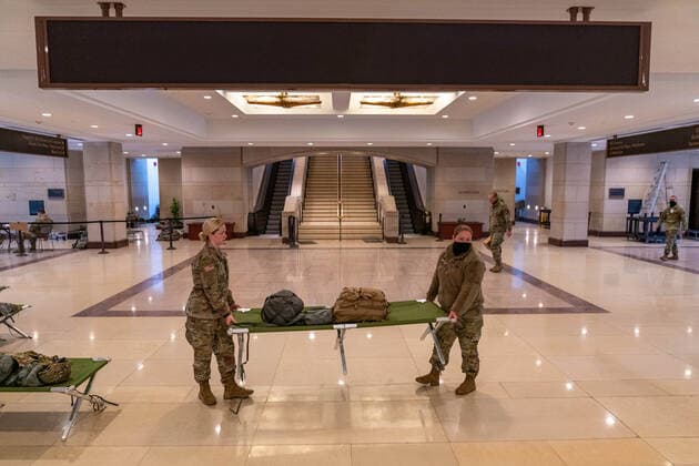 National Guard troops rest up inside the U.S. Capitol ahead of the inauguration for President-elect Joe Biden in Washington, DC on Monday, January 18, 2021. Security is even tighter given the recent events when pro-Trump MAGA mobs breached the security perimeter and penetrated the U.S. Capitol on Jan 6.  WAP20210118528 KenxCedeno