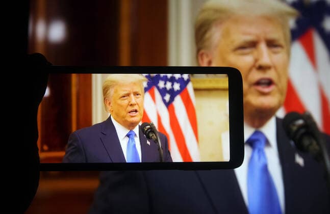 January 20, 2021, Ukraine: In this photo illustration the US President Donald Trump speaks at his farewell address during his last day in office, on a fragment of youtube video displayed on a mobile phone and a pc screen. Ukraine - ZUMAs197 20210120_zab_s197_006 Copyright: xPavloxGoncharx
