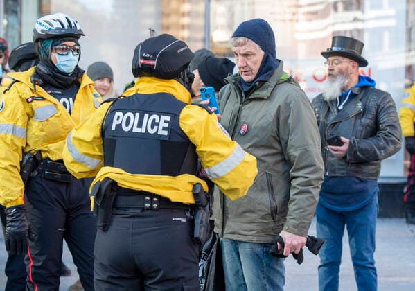 January 23, 2021, Toronto, on, Canada: Toronto Police talk with anti-mask protesters in Toronto on Saturday January 23, 2021. The protest travelled through the downtown core for hours and was not stopped by police. Toronto Canada  - ZUMAc35_ 20210123_zaf_c35_029 Copyright: xFrankxGunnx