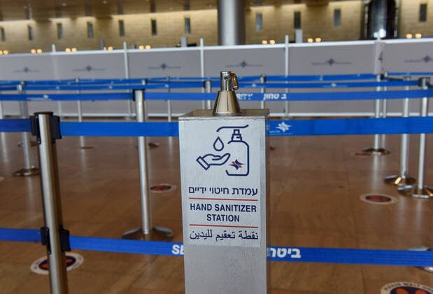 A hand sanitzer station in the departure hall of Israel s Ben Gurion Airport in Lod, near Tel Aviv, on Sunday, January 24, 2021.  JER2021012418 DEBBIExHILL