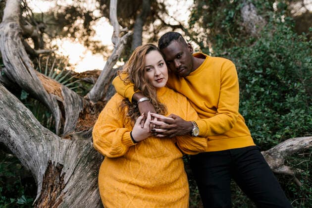 Man sitting with arm around on woman sitting at forest model released Symbolfoto EGAF01358