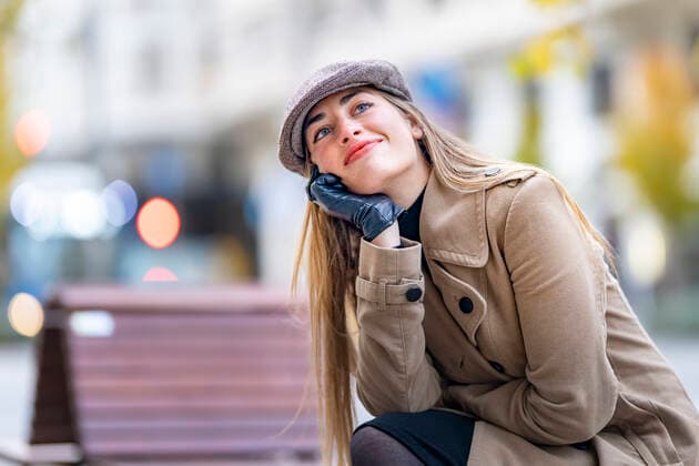 Woman with hand on chin contemplating outdoors model released Symbolfoto GGGF00715