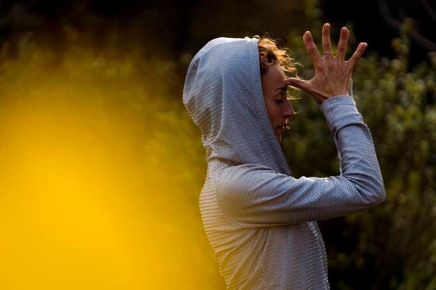 Athlete doing meditation while standing at park model released Symbolfoto MAUF03699