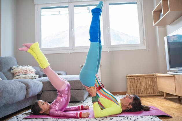 Mother and daughter doing stretching exercise at home model released Symbolfoto property released SNF00905