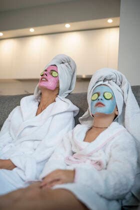 Mother and daughter with facial masks relaxing in living model released Symbolfoto property released SNF00945