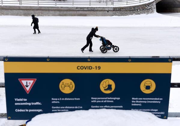 January 28, 2021, Ottawa, on, Canada: Skaters pass sign on COVID-19 measures on the Rideau Canal Skateway on its opening day in Ottawa, on Thursday, Jan. 28, 2021. Ottawa Canada  - ZUMAc35_ 20210128_zaf_c35_002 Copyright: xJustinxTangx