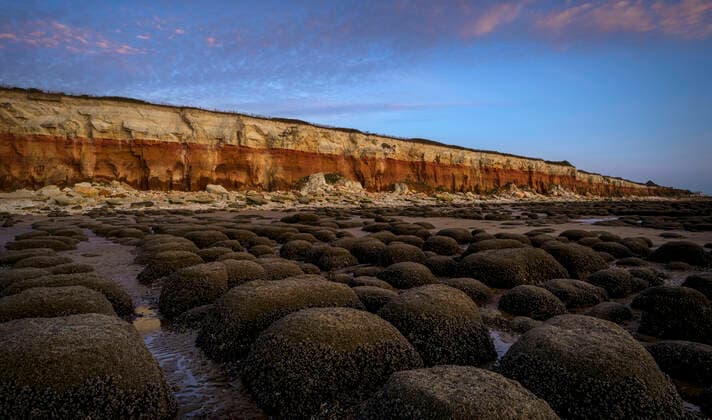 Creative Highlights World Barnacle encrusted bumps in front of the red and white striped cliffs of Hunstanton beach. Copyright: xRickxBowden LOOPxIMAGESx RBO00521007