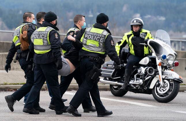January 29, 2021, Vancouver, BC, Canada: Members of the Extinction Rebellion get arrested after blocking the entrance to the Port of Vancouver, Friday, January 29, 2021. The protesters planned the march and blockade as a part of their anti-pipeline campaign. Vancouver Canada  - ZUMAc35_ 20210129_zaf_c35_069 Copyright: xJonathanxHaywardx