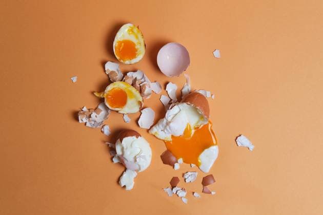 IMAGO Creative: Clickbait, Rezepte und Kochen Top view of soft boiled chicken eggs and eggshell scattered on peach background in studio Copyright: xFatimaxGuisadox Model Released