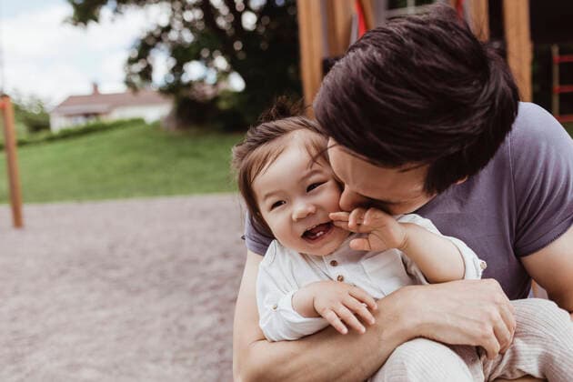 Creative Highlights Symbolbilder Father kissing smiling baby son in park Sweden, Stockholm, model released Copyright: xMaskotx , MA83921