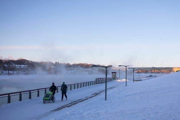 February 5, 2021, Saskatoon, SK, Canada: Pedestrians walk by River Landing on the South Saskatchewan River during an extreme cold warning in Saskatoon, Sask. on Friday, February 5, 2021. Saskatoon Canada  - ZUMAc35_ 20210205_zaf_c35_001 Copyright: xKaylexNeisx