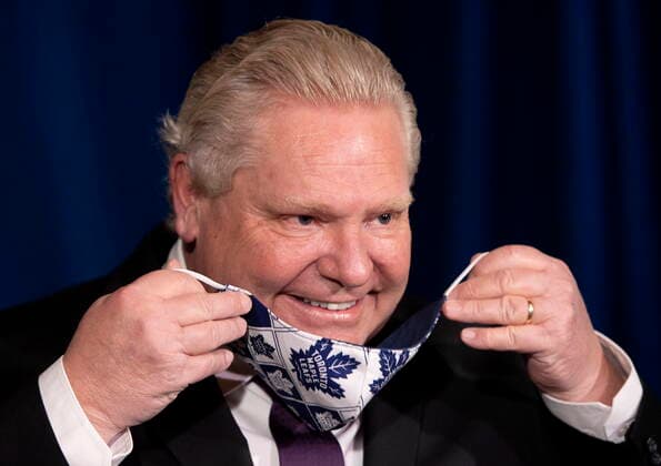 February 8, 2021, Toronto, on, Canada: Ontario Premier Doug Ford puts on his Toronto Maple Leafs mask during the daily briefing in Toronto on Monday, February 8, 2021. Toronto Canada  - ZUMAc35_ 20210208_zaf_c35_025 Copyright: xFrankxGunnx