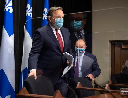 February 9, 2021, QUEBEC, PQ, Canada: Quebec Premier Francois Legault, left, andQuebec Health Minister Christian Dube, right walk in a news conference on the COVID-19 pandemic, Tuesday, February 9, 2021 at the legislature in Quebec City. Horacio Arruda, Quebec director of National Public Health, is reflected in the plexiglass QUEBEC Canada - ZUMAc35_ 20210209_zaf_c35_016 Copyright: xJacquesxBoissinotx