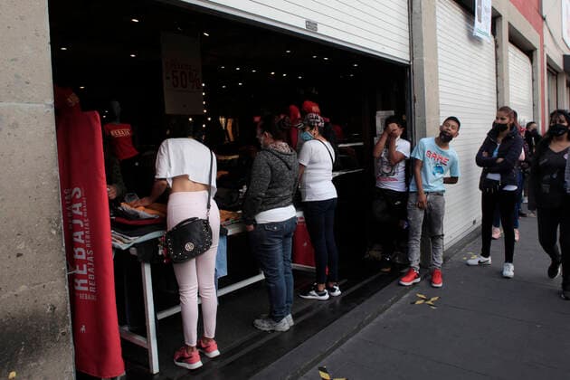 February 9, 2021, Mexico City, Mexico City, Mexico: Person queue to be allowed to enter a store, after closed several days due red alert by Covid. The Mexican Government allowed the reopening of stores, some shops make outside sell to prevent crowd of people, as an attempt to prevent spread of the Virus February 9, 2021 in Mexico City, Mexico Mexico City Mexico - ZUMAe321 20210209_zia_e321_034 Copyright: xAngelxMoralesxRizox