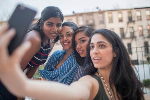 Young women taking a selfie at a party together model release HEX17012_TP_-9542 Copyright: xTOBIASxPRASSEx