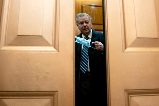 February 13, 2021, Washington, District of Columbia, USA: Senator Lindsey Graham, a Republican from South Carolina, puts a protective mask on while arriving to the U.S. Capitol in Washington, D.C., U.S., on Saturday, Feb. 13, 2021. The Senate approved 55-45 a request to consider calling witnesses in the second impeachment trial of Donald Trump, a move that may extend the trial that was expected to end within hours Washington USA - ZUMAs152 20210213_zaa_s152_132 Copyright: xStefanixReynoldsx-xPoolxViaxCnpx