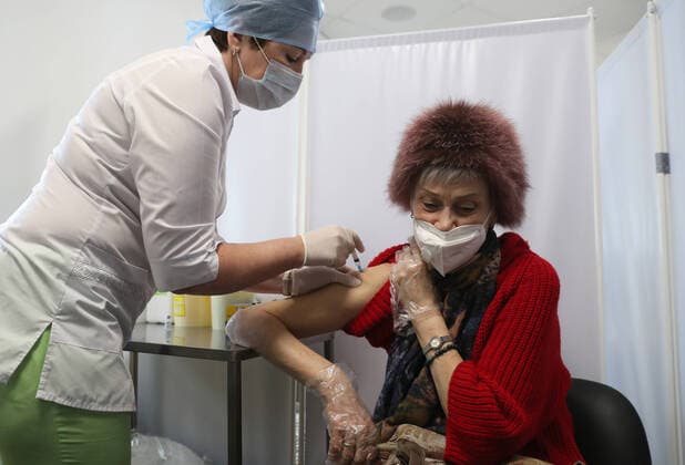 MOSCOW, RUSSIA â€“ FEBRUARY 17, 2021: A woman receives the Gam-COVID-Vac vaccine (under the brand name of Sputnik V) at a new temporary COVID-19 vaccination site in the VDNKh Exhibition Centre. A mobile vaccination team is providing vaccines free of charge and without prior sign-up. Since the start of the pandemic, Moscow has confirmed more than 960,600 cases of COVID-19. Since late January, the number of new confirmed cases has been increasing in the Russian capital by more than 1,200 daily. Sergei Savostyanov TASS  TS0F7010