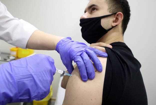 MOSCOW, RUSSIA - FEBRUARY 17, 2021: A man receives an injection of the Gam-COVID-Vac (marketed as Sputnik V) vaccine against COVID-19 in a vaccination room at the Evropeisky Europe shopping centre. The vaccination team works free of charge, no prior appointment required. Stanislav Krasilnikov TASS  TS0F7098
