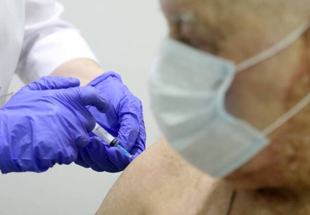 MOSCOW, RUSSIA - FEBRUARY 17, 2021: A man receives an injection of the Gam-COVID-Vac (marketed as Sputnik V) vaccine against COVID-19 in a vaccination room at the Evropeisky Europe shopping centre. The vaccination team works free of charge, no prior appointment required. Stanislav Krasilnikov TASS  TS0F709A