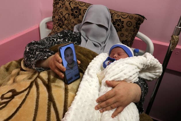 February 18, 2021, khan Younis, Gaza Strip, Palestinian Territory: The wife of the Palestinian prisoner Mohammad al-Qudra, holds her newborn baby, from whom she conceived with sperm smuggled out of an Israeli prison, at Nasser Medical Complex in khan Younis in the southern of Gaza strip on February 18, 2021. Since 2004, Palestinian security prisoners, who are denied conjugal visitations by their wives, have tried to smuggle their sperm out of Israeli prisons, so that their wives can be inseminated in fertility clinics in the West Bank and Ghazza, and bear them children khan Younis Palestinian Territory - ZUMAap3_ 20210218_zaf_ap3_174 Copyright: xAshrafxAmrax