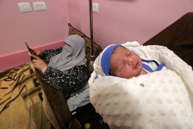 February 18, 2021, khan Younis, Gaza Strip, Palestinian Territory: Relatives of the Palestinian prisoner Muhammad al-Qudra carry the newborn, at Nasser Medical Complex in khan Younis in the southern of Gaza strip on February 18, 2021. Eman al-Qudra gave birth to her newborn in a successful smuggling of sperm to lead to a pregnancy. Since 2004, Palestinian security prisoners, who are denied conjugal visitations by their wives, have tried to smuggle their sperm out of Israeli prisons, so that their wives can be inseminated in fertility clinics in the West Bank and Ghazza, and bear them children khan Younis Palestinian Territory - ZUMAap3_ 20210218_zaf_ap3_194 Copyright: xAshrafxAmrax
