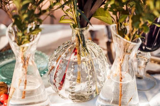 High angle of transparent glass vases with bunches of fresh flowers placed on table for event Copyright: xJavierxBravox Model Released