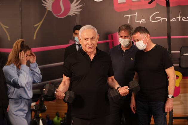 Israeli Prime Minister Benjamin Netanyahu visits a fitness gym ahead of the re-opening of the branch in Petah Tikva, Israel on Saturday, February 20, 2021, Israel continues lifting the lockdown with the opening of gyms, hotels, and shopping centers starting February. 21. Pool photo by Tal Shahar  JERX20210220206 TalxShahar