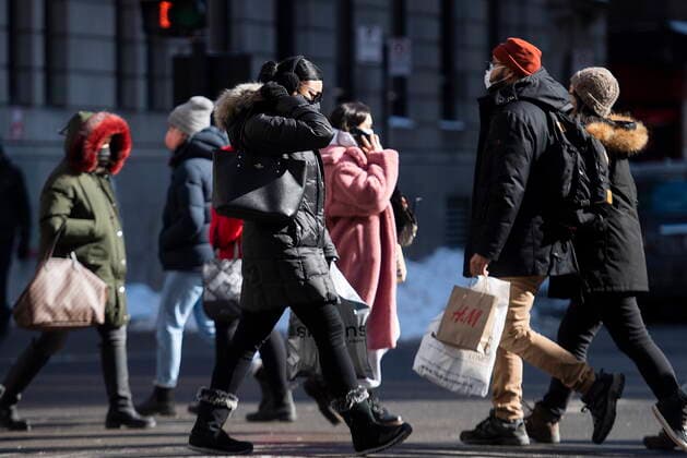February 21, 2021, Montreal, PQ, Canada: People wear face masks as they walk along a street in Montreal, Sunday, February 21, 2021, as the COVID-19 pandemic continues in Canada and around the world. Montreal Canada  - ZUMAc35_ 20210221_zaf_c35_003 Copyright: xGrahamxHughesx