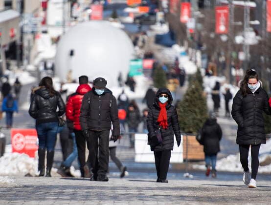 February 21, 2021, Montreal, PQ, Canada: People wear face masks as they walk along a street in Montreal, Sunday, February 21, 2021, as the COVID-19 pandemic continues in Canada and around the world. Montreal Canada  - ZUMAc35_ 20210221_zaf_c35_006 Copyright: xGrahamxHughesx