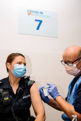 SA COVID19 VACCINE ROLLOUT, Front-line worker SAPOL Senior Sergeant Amanda Kuchel receives the Pfizer Vaccine from a COVID-19 Vaccinator Health Care Worker at the Royal Adelaide Hospital in Adelaide, Monday, February 22, 2021. Australia will begin its roll out of the Pfizer coronavirus vaccine on Monday, the country s most complicated logistical exercise to date.( NO ARCHIVING, EDITORIAL USE ONLY, NO USE IN BOOKS WITHOUT CONSENT ADELAIDE SA AUSTRALIA Copyright: xMORGANxSETTEx 20210222001522254689