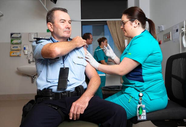 QLD COVID19 VACCINE ROLLOUT, Police Inspector Owen Hortz (left) is administered a Pfizer coronavirus vaccination by a clinical nurse at the Gold Coast University Hospital on the Gold Coast, Monday, February 22, 2021. Australia will begin its roll out of the Pfizer coronavirus vaccine on Monday, the country s most complicated logistical exercise to date. ( NO ARCHIVING, EDITORIAL USE ONLY, NO USE IN BOOKS WITHOUT CONSENT GOLD COAST QLD AUSTRALIA  Copyright: xNIGELxHALLETTx 20210222001522281797