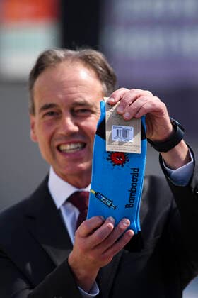 News Bilder des Tages ACT COVID19 VACCINE ROLLOUT, Australian Health Minister Greg Hunt holds up a pair of socks depicting a syringe and a virus after the start of the Biotech Pfizer COVID-19 vaccine rollout at the COVID-19 surge centre in Canberra, Monday, February 22, 2021. Australia will begin its roll out of the Pfizer coronavirus vaccine on Monday, the country s most complicated logistical exercise to date. ( NO ARCHIVING, EDITORIAL USE ONLY, NO USE IN BOOKS WITHOUT CONSENT CANBERRA ACT AUSTRALIA  Copyright: xLUKASxCOCHx 20210222001522295545