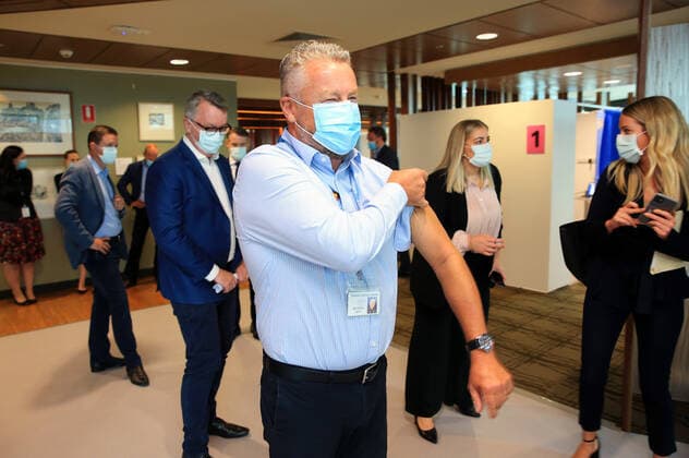VIC COVID19 VACCINE ROLLOUT, Dr Chris Quinn, who has been working in hotel quarantine rolls up his sleeve as he prepares to receive one of the first Pfizer coronavirus vaccines at Austin Health in Melbourne, Monday, February 22, 2021. Australia will begin its roll out of the Pfizer coronavirus vaccine on Monday, the country s most complicated logistical exercise to date. ( NO ARCHIVING, EDITORIAL USE ONLY, NO USE IN BOOKS WITHOUT CONSENT MELBOURNE VIC AUSTRALIA  Copyright: xMARKxSTEWARTx 20210222001522296354