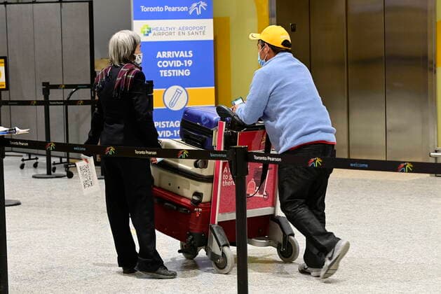 February 22, 2021, Toronto, on, Canada: Travellers, who are not affected by new quarantine rules, arrive at Terminal 3 at Pearson Airport in Toronto early Monday, February 22, 2021. Prime Minister Justin Trudeau announced that all travellers entering Canada by air would have to quarantine in a hotel for three days at their own expense starting later today. Toronto Canada  - ZUMAc35_ 20210222_zaf_c35_005 Copyright: xFrankxGunnx