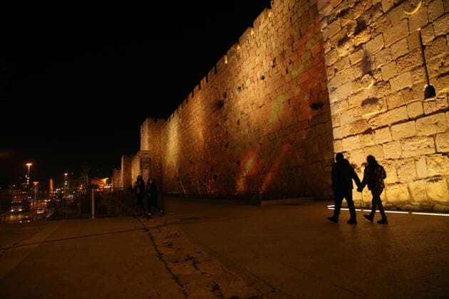 (210222) -- JERUSALEM, Feb. 22, 2021 -- A lightshow as part of the Follow the Lights event launched by Jerusalem s municipal authority amid COVID-19 pandemic is displayed over the wall of Jerusalem s Old city on Feb. 21, 2021. (Photo by Xinhua) MIDEAST-JERUSALEM-LIGHT SHOW MuammarxAwad 