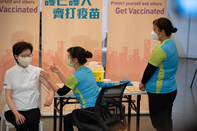 February 22, 2021, Hong Kong, China: Carrie Lam (L), Hong Kong Chief Executive receives a dose of the COVID-19 vaccine at the Community Vaccination Centre at the Hong Kong Central Library..Hong Kong Chief Executive Carrie Lam and members of her cabinet receive their first dose of of the COVID-19 vaccine in a bid to boost public confidence to the vaccine as the vaccination program for the public will begin on 26th February. Hong Kong China - ZUMAs197 20210222_zaa_s197_002 Copyright: xGeovienxSox