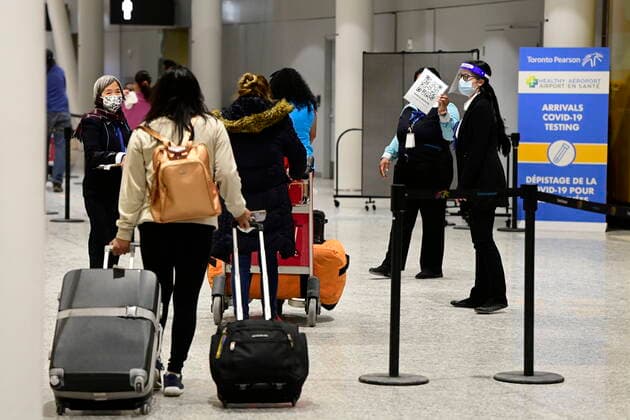 February 22, 2021, Toronto, on, Canada: Travellers, who are not affected by new quarantine rules, arrive at Terminal 3 at Pearson Airport in Toronto early Monday, February 22, 2021. Prime Minister Justin Trudeau announced that all travellers entering Canada by air would have to quarantine in a hotel for three days at their own expense starting later today. Toronto Canada - ZUMAc35_ 20210222_zaf_c35_008 Copyright: xFrankxGunnx
