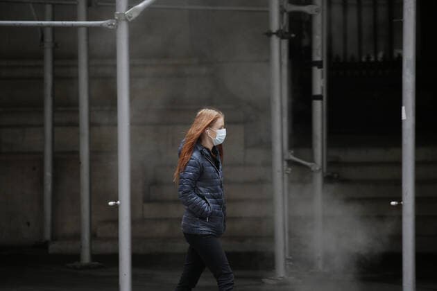 A pedestrian walks wearing a face mask to protect from and to prevent the spread of the coronavirus on Wall Street in New York City on Monday February 22, 2021. COVID-19 deaths have now surpassed the 500,000 mark in the United States.  NYP20210222106 JohnxAngelillo
