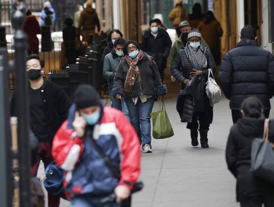 Pedestrian walk wearing face masks to protect from and to prevent the spread of the coronavirus on Wall Street in New York City on Monday February 22, 2021. COVID-19 deaths have now surpassed the 500,000 mark in the United States.  NYP20210222110 JohnxAngelillo