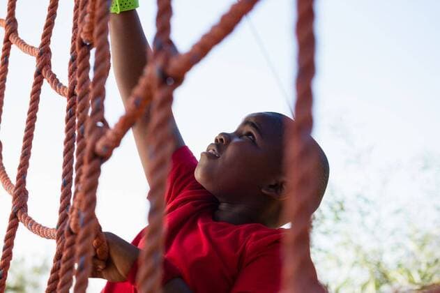 Boy climbing a net during obstacle course training Boy climbing a net during obstacle course training in the boot camp, model released, , property released, Cape Town, South Africa, 16.03.2017, 1008480.jpg, boot, camp, boot camp, park, sky, summer, sunny, sportswear, sweatband, athletic shoes, athlete, athletic, sport, sports, rope climbing, obstacle course, obstacle, net, holding, climbing, practice, practicing, training, healthy lifestyle, wellness, wellbeing, active, activity, fit, fitness, health, healthy, physical, childhood, determined, determination, effort, vitality, strength, endurance, confidence, leisure, lifestyle, losing weight, weight loss, overweight, chubby Child, Boy, Male, Black, 8-9 Years, Boys, African Ethnicity Outdoor