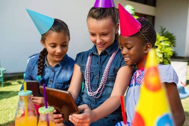 Female friends taking selfie Female friends taking selfie during birthday party in yard, model released, , property released, Cape Town, South Africa, 2017-04-24T23:00:00.000Z, 1049580.jpg, birthday, celebration, party, togetherness, childhood, event, party hat, friend, friendship, bonding, sitting, casual clothing, lifestyle, table, yard, fun, excitement, enjoyment, smiling, toothy smile, happiness, necklace, food and drink, drink, bottle, holding, global communications, memories, selfie, wireless technology, tablet computer, digital tablet, using, tablet pc, tablet, side by side, focus shot Child, Girl, Female, Black, Boy, Male, Mixed-Race, Caucasian, 6-7 Years, Girls, African Ethnicity, 8-9 Years, Boys, Mixed-Race Person, Caucasian Ethn