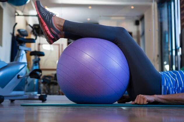 Mid-section of senior woman resting her legs on exercise ball Mid-section of senior woman resting her legs on exercise ball at clinic, model released, , property released, Cape Town, South Africa, 2017-04-22T23:00:00.000Z, 1052879.jpg, medical, clinic, hospital, physical therapist, physiotherapy, patient, wooden floor, casual clothing, exercise ball, lying, mat, exercise, exercising, recuperation, treatment, healing, wellness, healthy, wellbeing, care, cure, recovery, health service, healthcare, bodycare, healthcare and medicine, occupation, expertise, profession, professional, senior woman, senior citizen, retired, senior, retirement 60s, Senior, Elderly, Woman, Female, Caucasian, 65-69 Years, Senior Women, Caucasian Ethnicity