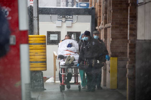 (210223) -- NEW YORK, Feb. 23, 2021 -- Medical workers wheel a patient in front of Maimonides Medical Center in the Brooklyn Borough of New York, the United States, Feb. 22, 2021. The United States reached the grim milestone of half a million coronavirus deaths on Monday, according to the Center for Systems Science and Engineering (CSSE) at Johns Hopkins University. (Photo by Xinhua) U.S.-NEW YORK-COVID-19-DEATH-HALF A MILLION MichaelxNagle 