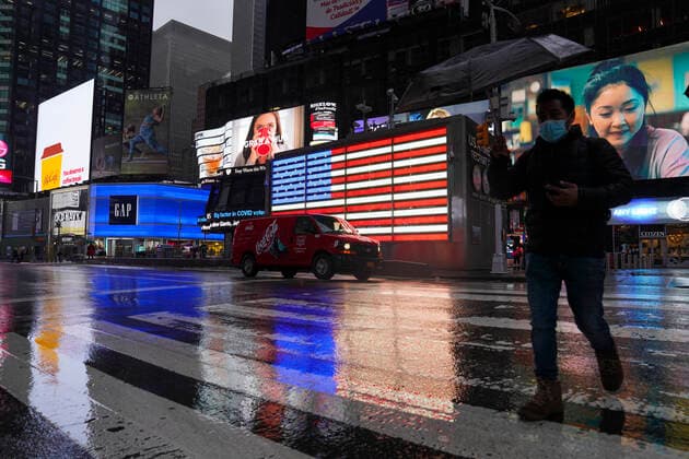 (210223) -- NEW YORK, Feb. 23, 2021 -- A man walks on Times Square in New York, the United States, Feb. 22, 2021. The United States reached the grim milestone of half a million coronavirus deaths on Monday, according to the Center for Systems Science and Engineering (CSSE) at Johns Hopkins University. ) U.S.-NEW YORK-COVID-19-DEATH-HALF A MILLION WangxYing 