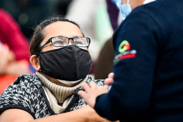 (210223) -- ECATEPEC, Feb. 23, 2021 -- A medical worker inoculates a citizen with a COVID-19 vaccine developed by Chinese pharmaceutical company Sinovac at a vaccination site in Ecatepec, Mexico, Feb. 22, 2021. Mexican health authorities on Monday began to vaccinate older adults with a COVID-19 vaccine developed by Chinese pharmaceutical company Sinovac, after a shipment of doses arrived on Saturday. Mexico s government designated the first shipment of the Sinovac vaccine to arrive in Ecatepec, a city in central State of Mexico that lies on the outskirts of the capital Mexico City. Early in the day, brigades of healthcare workers began to administer the vaccine to hundreds of residents aged 60 and over who went to the Las Americas 