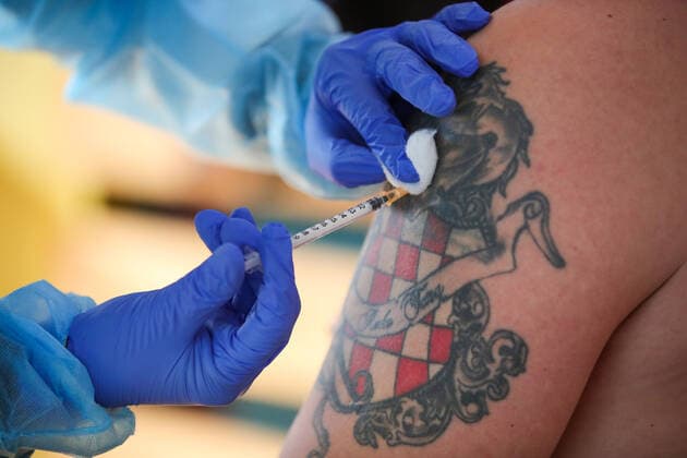 Vaccination in Zagreb, Croatia A man receive coronavirus disease (COVID-19) vaccine during a mass vaccination in Zagreb, Croatia on February 23, 2021 SanjinxStrukic PIXSELL