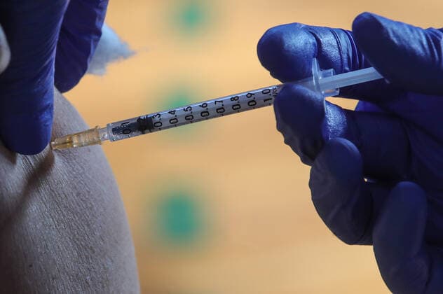 Vaccination in Zagreb, Croatia A man receive coronavirus disease (COVID-19) vaccine during a mass vaccination in Zagreb, Croatia on February 23, 2021 SanjinxStrukic PIXSELL